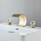 Lumière brushed gold widespread waterfall faucet with crystal knobs